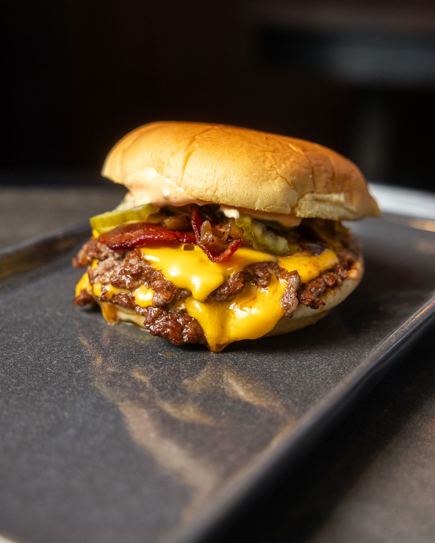 Double smash burger with melted American cheese and pickles at Smokey Soul Footscray