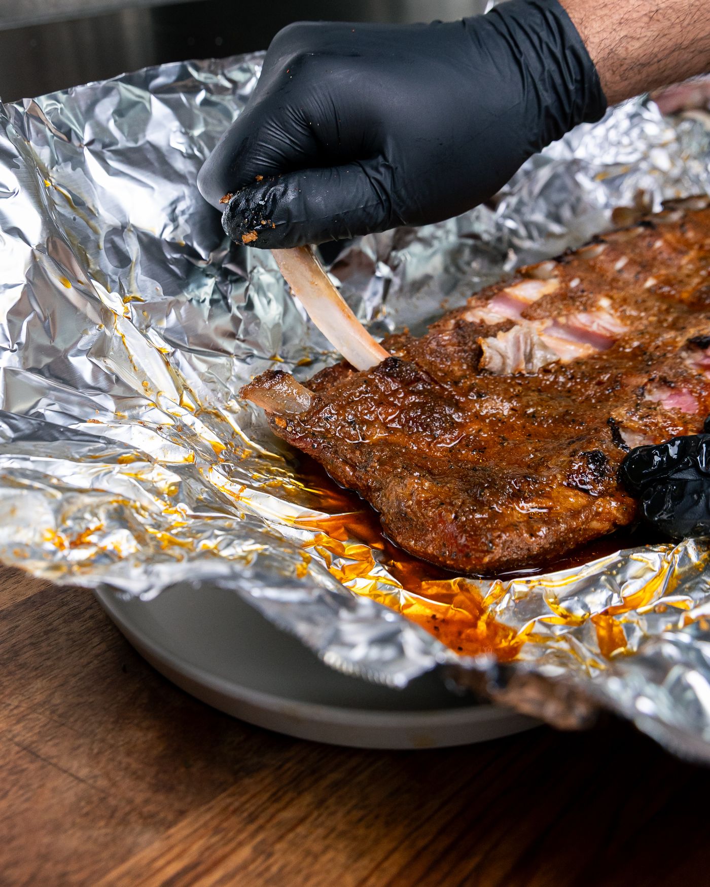 Rack of smoked pork ribs unwrapped from butcher foil